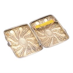 Edwardian silver cigarette case, embossed with floral decoration, hallmarked George Frank Bickerton, Birmingham 1901, together with a silver vesta case, six silver thimbles and three plated thimbles, miniature silver mounted mirror, mother of pearl handled silver fruit knife, and two button hooks