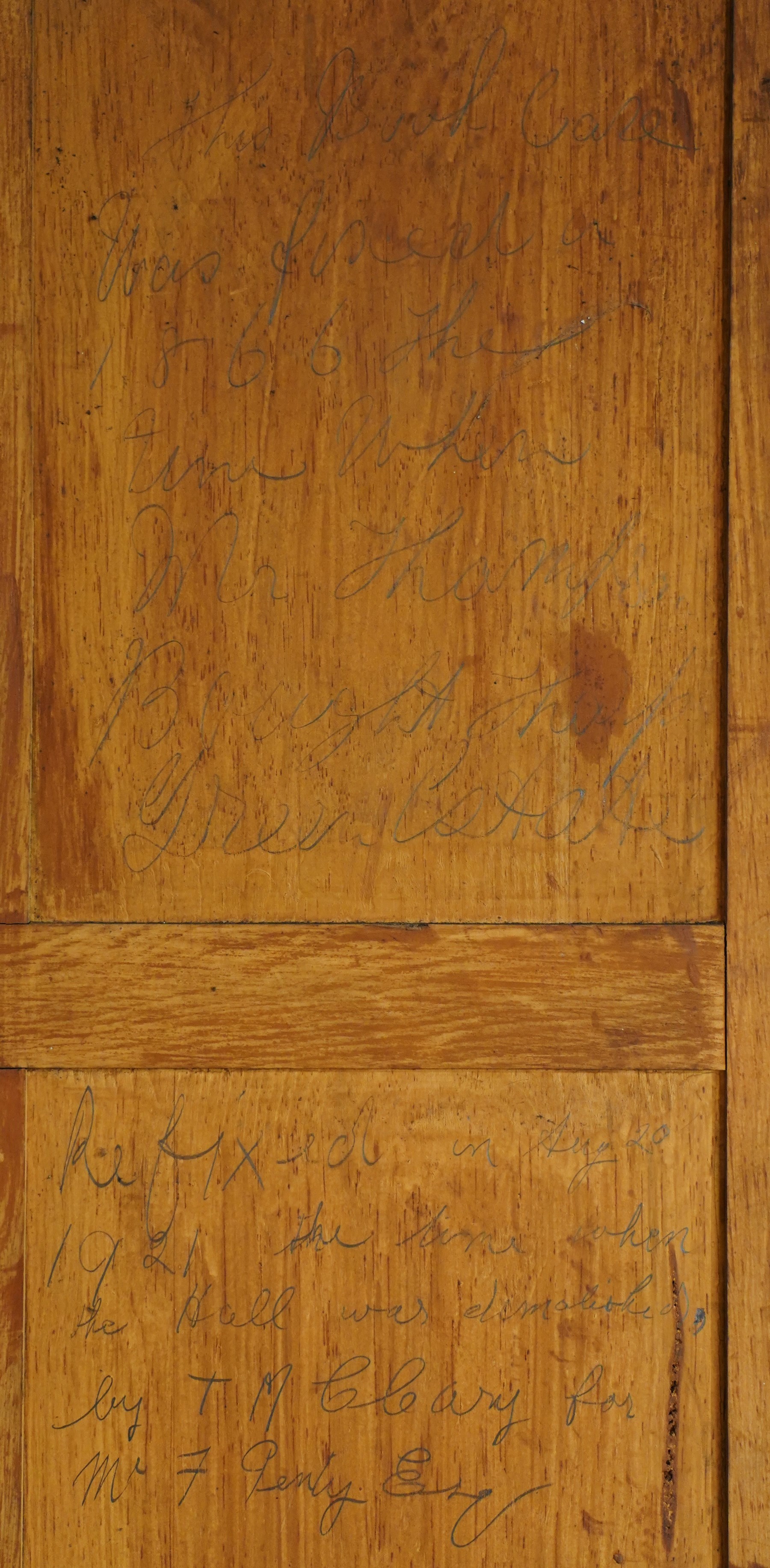 Large early 19th century Country House mahogany breakfront library bookcase, the projecting moulded cornice over a frieze applied with carved flowerhead paterae, the open panelled upper section fitted with adjustable shelves and shaped valances, divided by moulded pilasters with acanthus-carved corbels, the projecting base enclosed by eight panelled cupboard doors with central turned canted pilaster, on plinth base