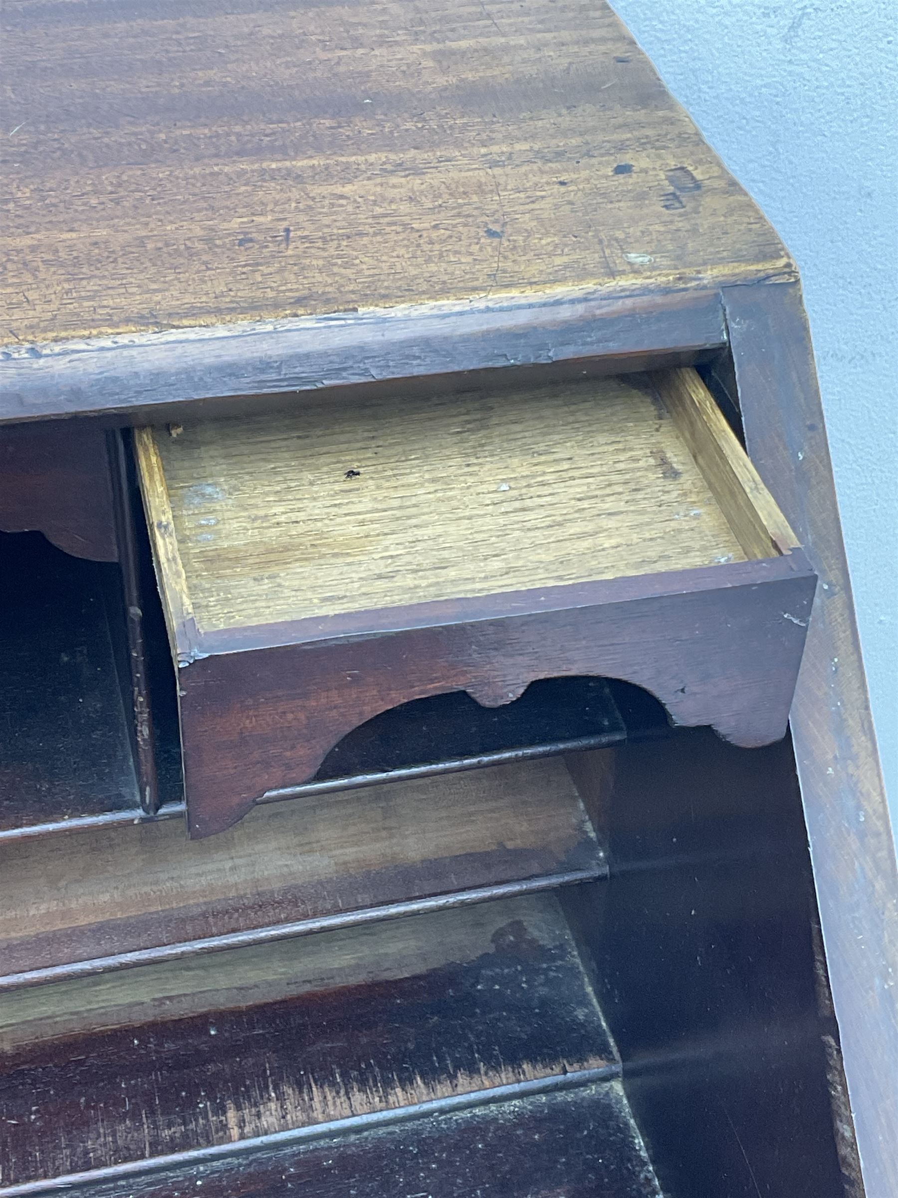 George III mahogany bureau, the conch inlaid fall front enclosing pigeon holes, shelves and central cupboard with inlaid flower motif, four graduating cock-beaded drawers below each with brass handles, lower moulded edge over shaped bracket feet