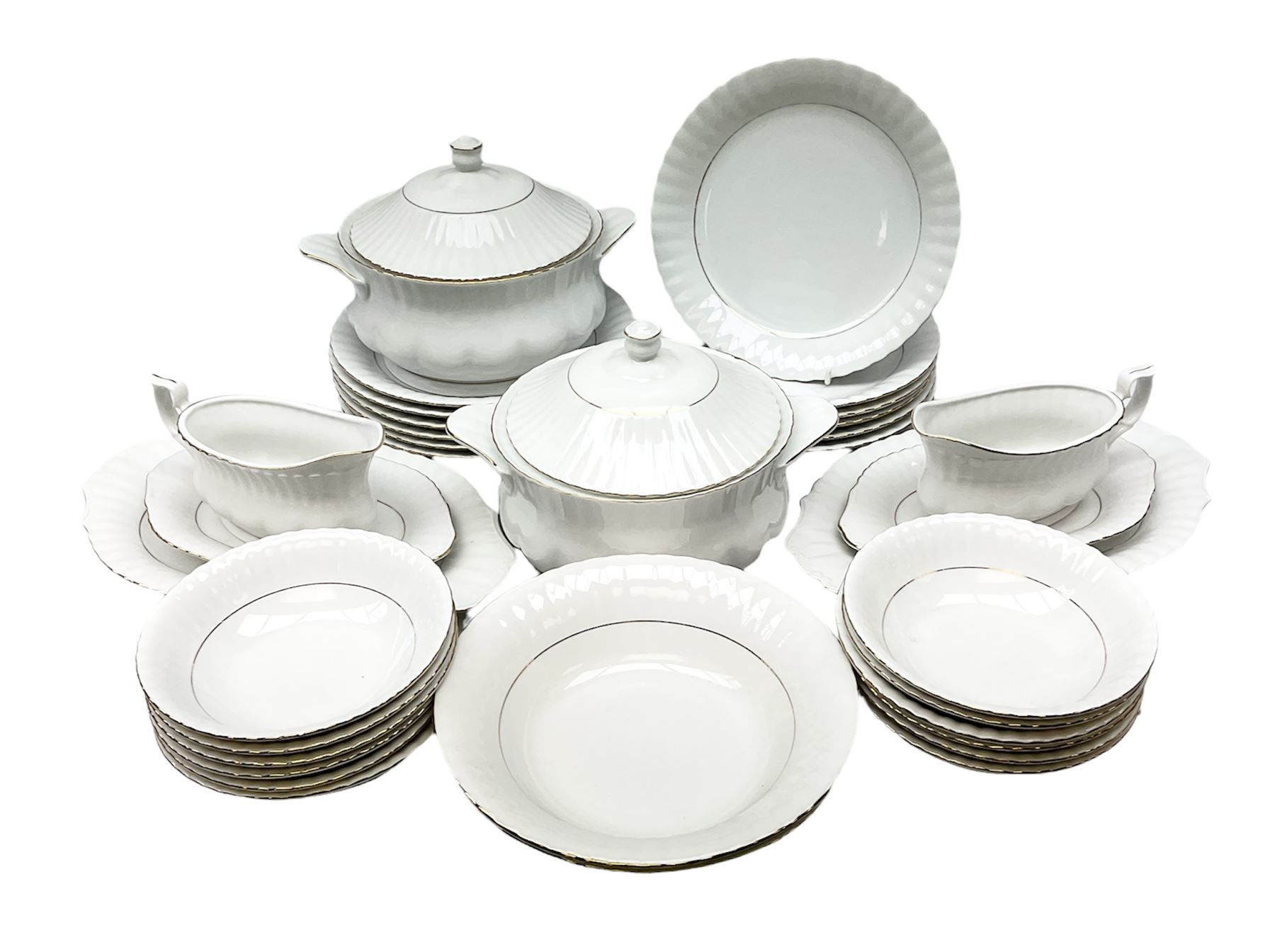 Chodziez Polish dinner wares decorated in white and gilt to include lidded twin handled tureens, bowls, plates etc