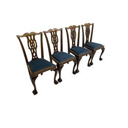 Set four George III Chippendale-style mahogany dining chairs, shaped serpentine cresting rail with pierced and splat back, drop-in seat upholstered in blue fabric, raised on cabriole supports with ball and claw feet