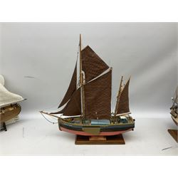 Eight model ships or boats including fishing boat with fish, nets and buoyancy aid, two mast sailing ship complete with cannons, two mast yacht with detailed rigging and life boat etc, the largest L72cm, H60cm