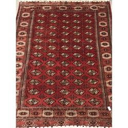 Turkman Tekke Bokhara red ground rug, the field and border decorated with guls, 177cm x 213cm