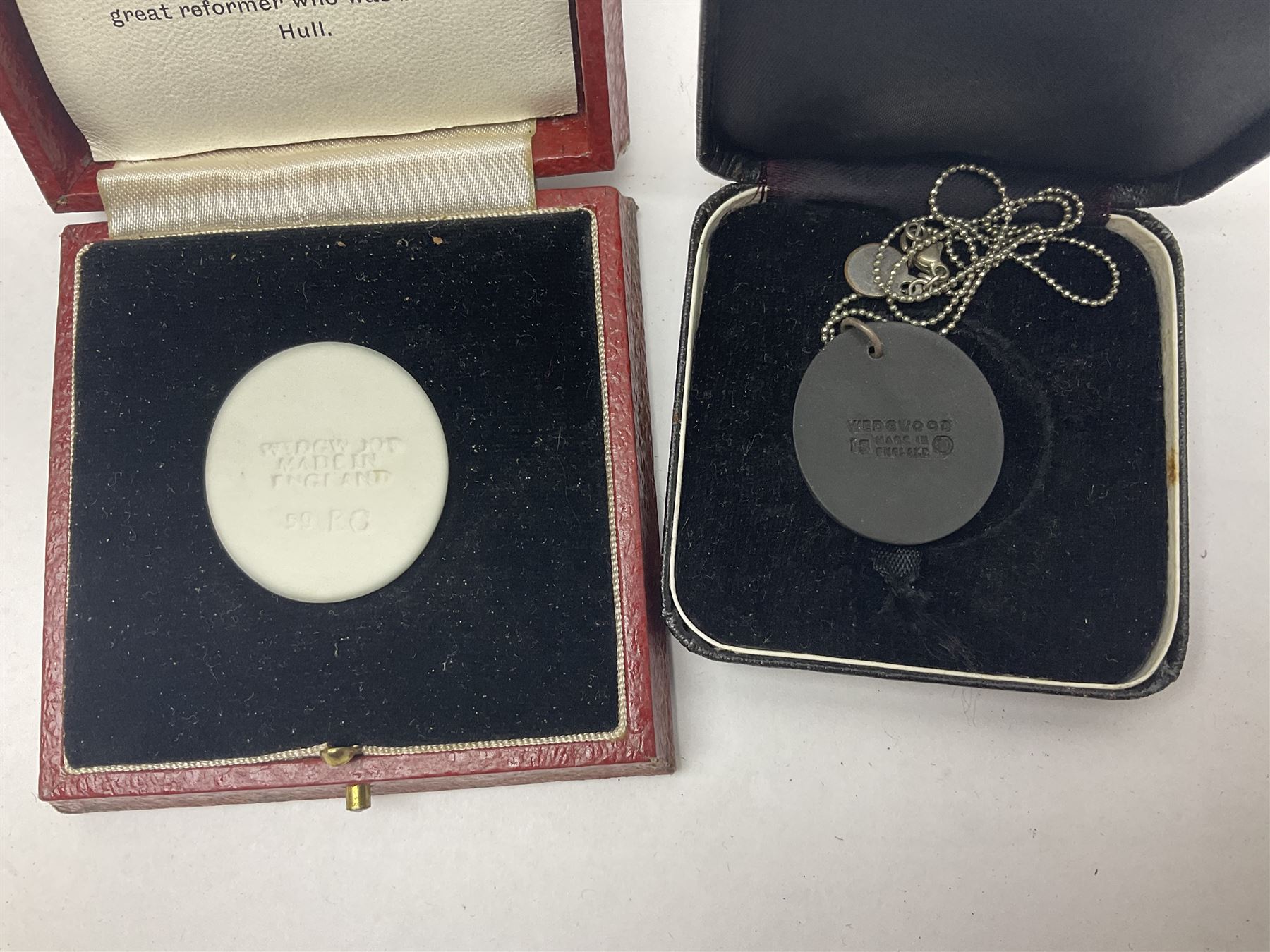 Group of William Wilberforce Abolition of Slavery items, comprising Wedgwood black on cane Jasperware pin tray, Wedgwood light blue Jasperware plate, and two Wedgwood oval medallion pendants, each depicting a kneeling figure beneath the inscription 'AM I NOT A MAN AND A BROTHER?', an Eastgate pottery plaque decorated in relief with a kneeling figure before William Wilberforce, a Hull Museum Publications pamphlet titled 'Medals, Tokens, etc., Issued in Connection with William Wilberforce and the Abolition of Slavery', by Thomas Sheppard, dated 1916, and an antique print depicting William Wilberforce after the original portrait by George Richmond, (7)