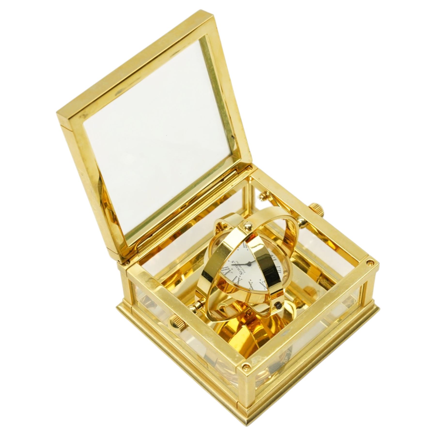 Sewills of Liverpool gilt gimbal mounted desk clock with white dial in brass and bevelled glass square case 8cm