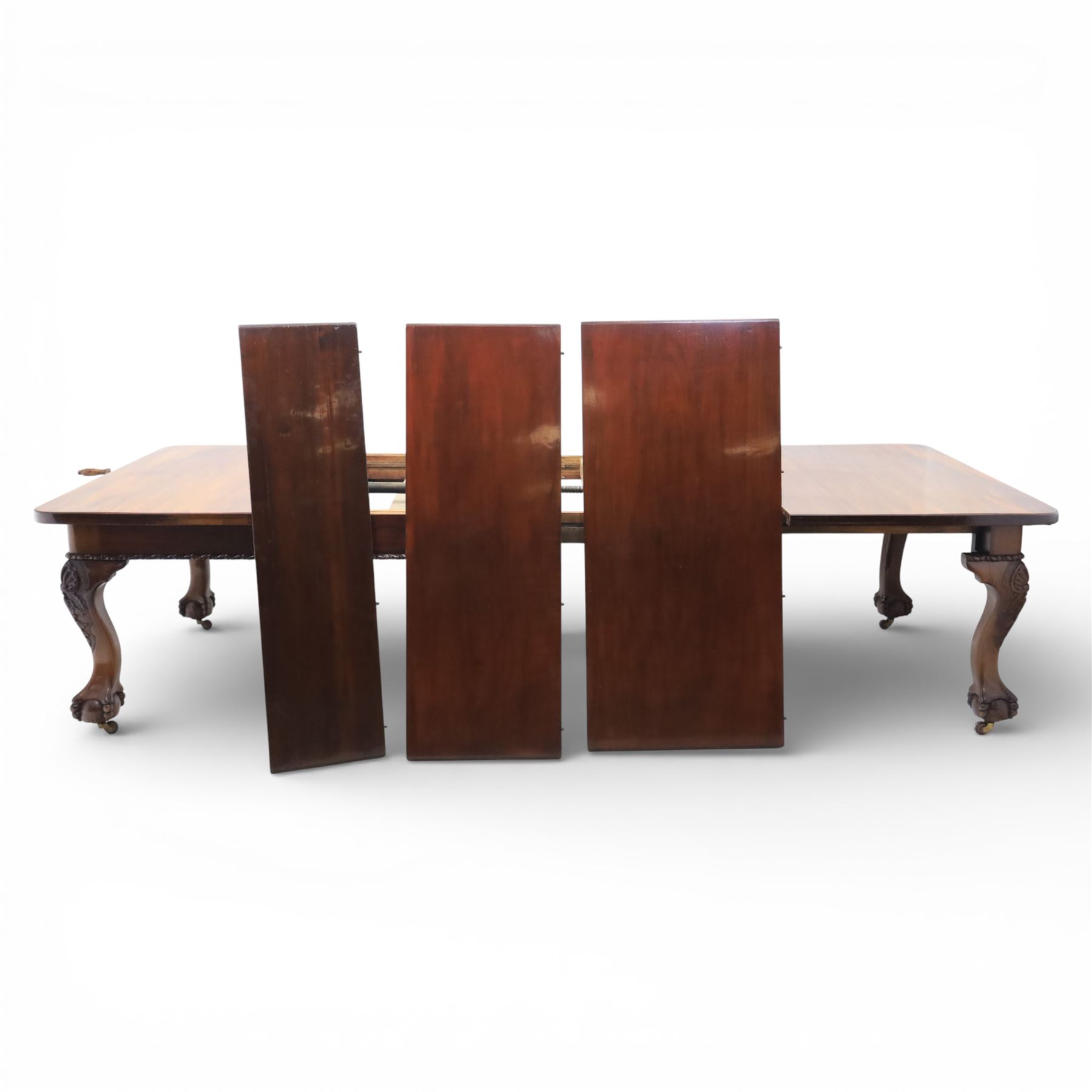 19th century mahogany extending dining table and eight chairs, rectangular top with rounded corners and additional leaves, plain frieze with carved gadrooned edge detail, raised on cabriole supports terminating in ball and claw feet, together with a set of eight mahogany dining chairs including two carvers, the chairs with curved top rails and pierced splats, upholstered drop-in seats, on turned supports

(Table extends to 312cm)