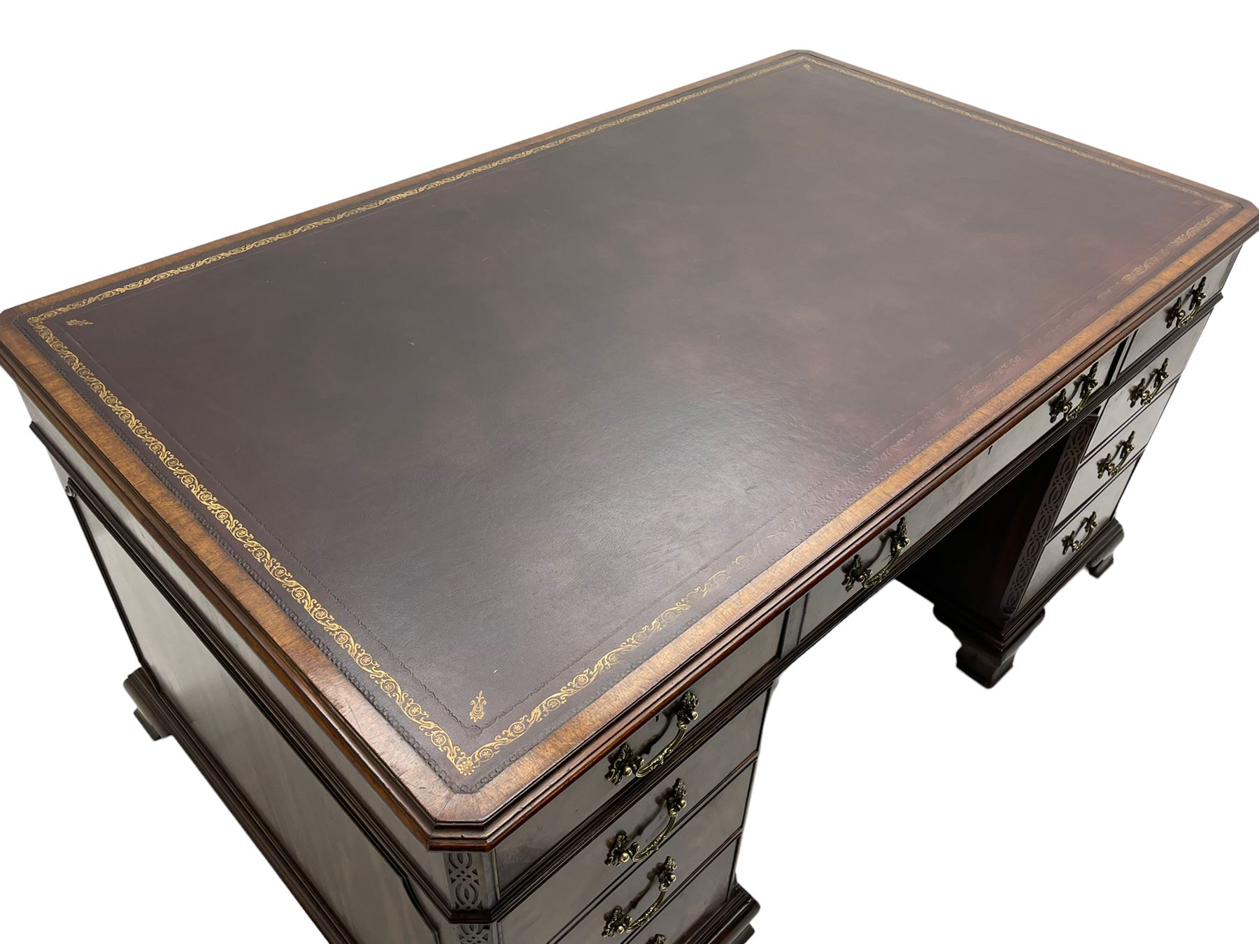 Large Georgian design mahogany twin pedestal partner's desk, moulded rectangular top with canted corners and inset leather writing surface, fitted with nine drawers and two cupboards, the pedestals with canted uprights decorated with blind fretwork, on ogee bracket feet