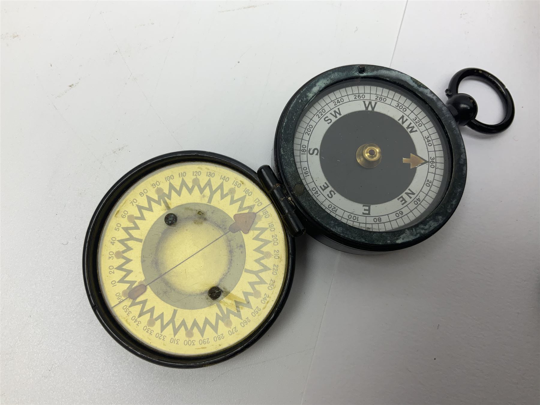 WW1 Short & Mason Ltd 'The Magnapole' black japanned brass field compass in leather carrying case; WW1 trench art paper knife inscribed Dixmude; and small quantity of cloth badges etc