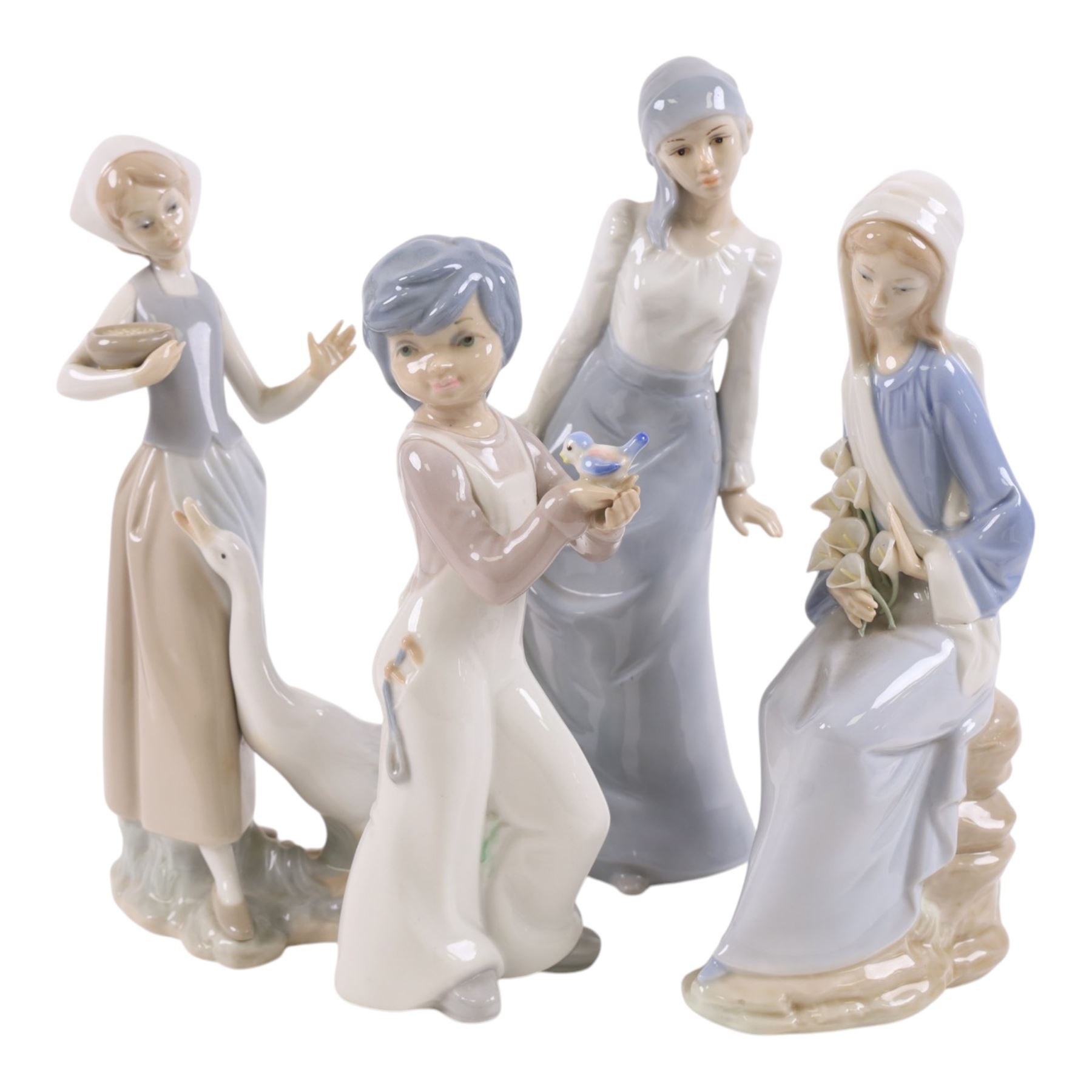 Two Lladro figures, Girl with Calla Lilies and Girl Feeding Goose, together with two other similar figures  