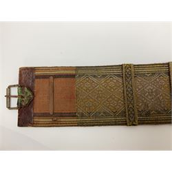 Late 19th century Yemeni Tuza jambiya as worn by religious elite, the 20.5cm curving blade with raised medial ridge, the horn hilt with pique style studwork, in a leather wrapped wooden scabbard with pierced metal mount and leather belt applied with embroidered 'gold' and 'silver' thread work panel; dagger L36cm overall, belt L84cm