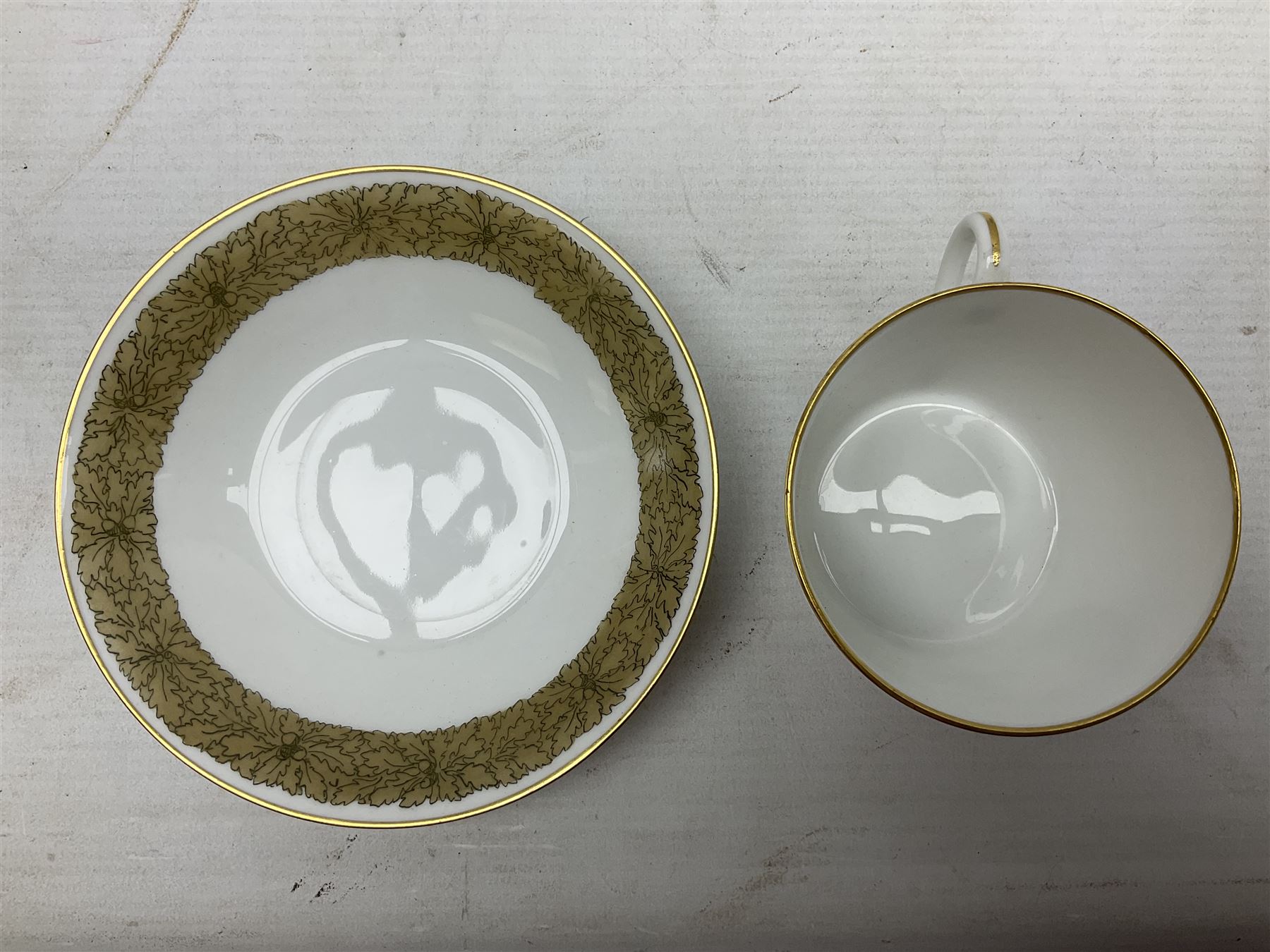 WW2 Nymphenburg cups and saucer, decorated with Imperial German Iron Cross encircled in a foliate boarder with gilt edging, with printed mark beneath 