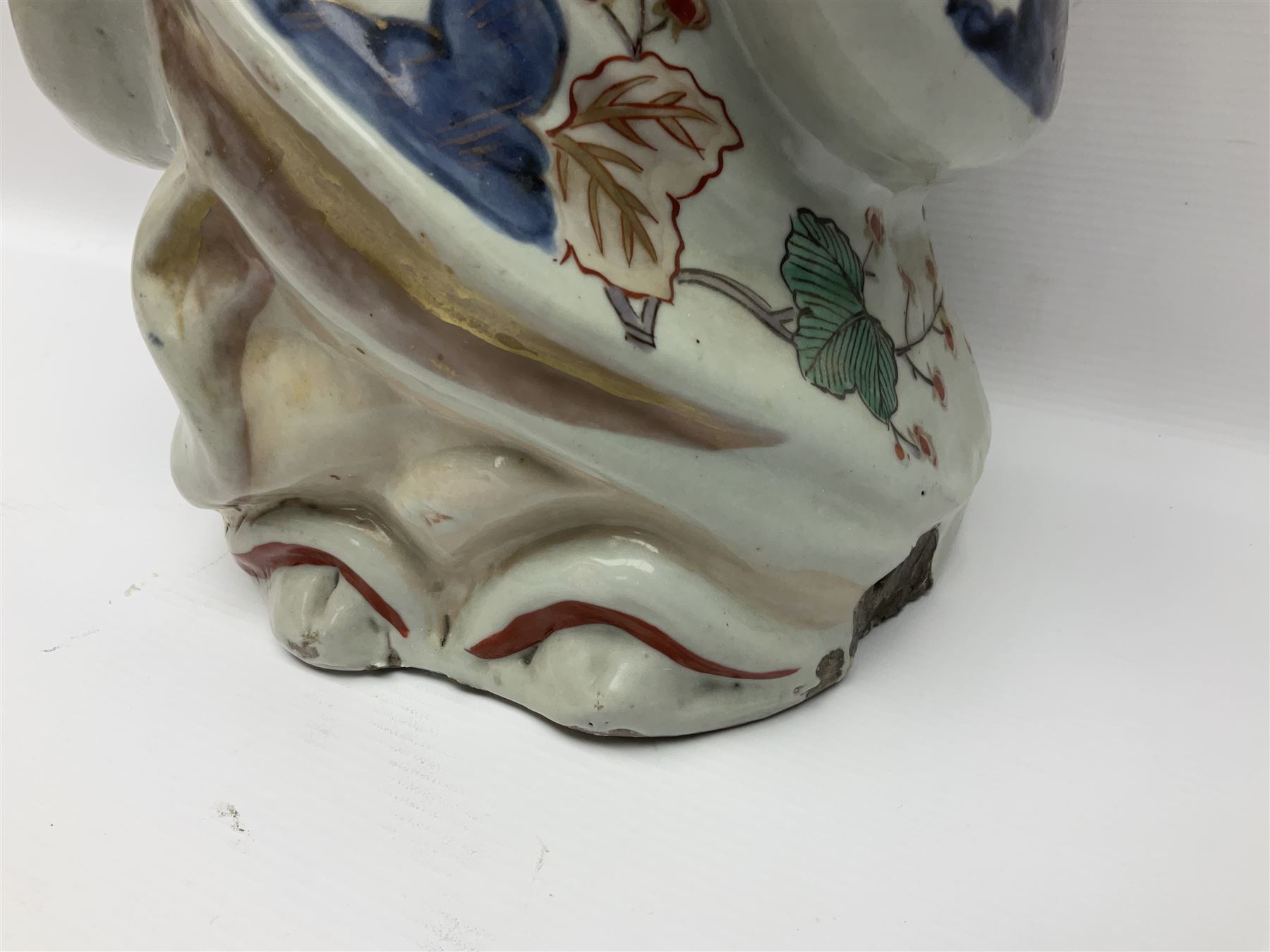 Large Japanese Imari porcelain figure, modelled as a Bijin, wearing a long kimono decorated with apple blossom and leafy branches on a white ground, with gilt detailing, possibly Edo period, H63cm