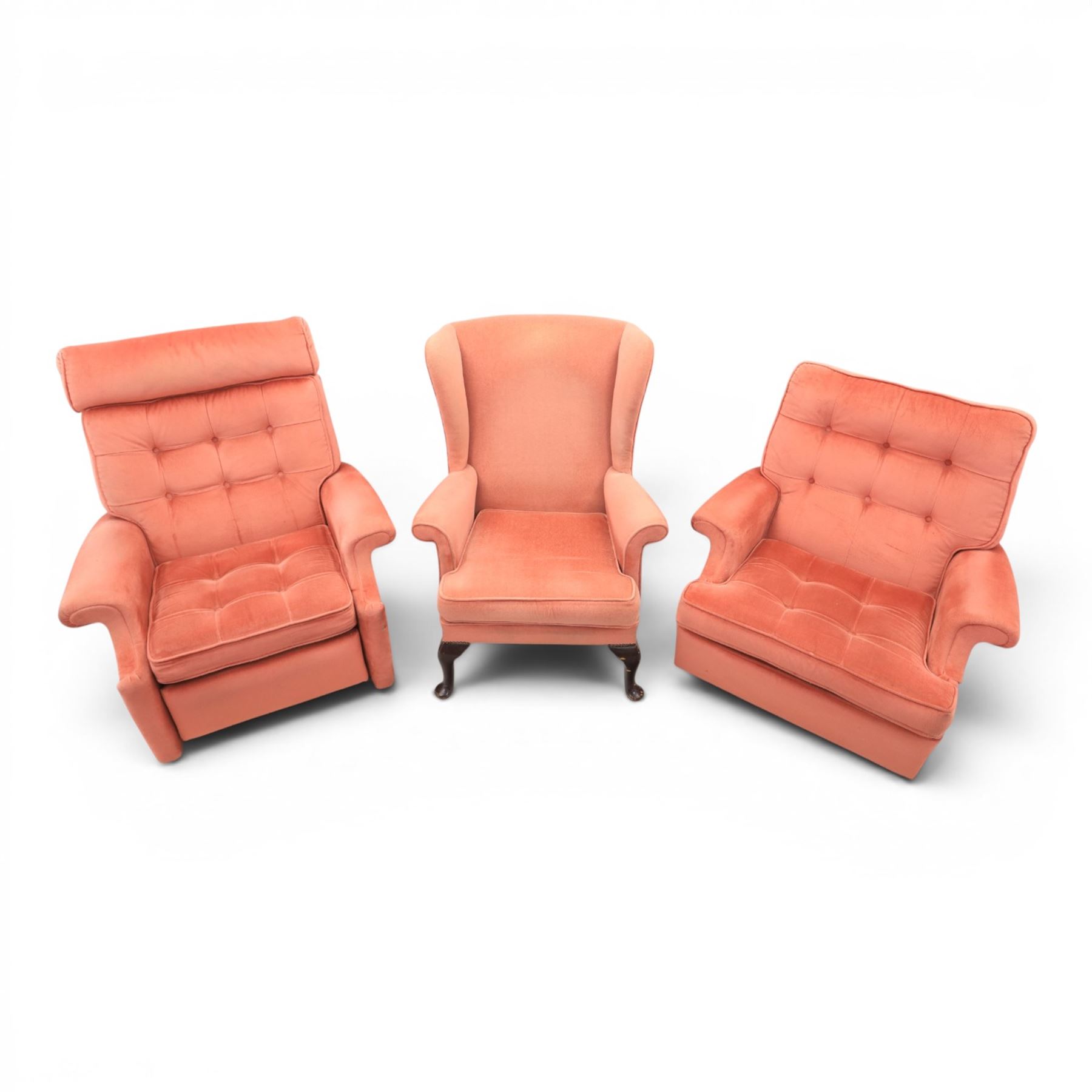 Parker Knoll - mid-century armchair suite, 'Model N30' recliner armchair with headrest and deep buttoned seat and back raised on castors, a wide armchair with deep button back and seat raised on castors, a wingback chair with flared scrolled arms, raised on cabriole supports