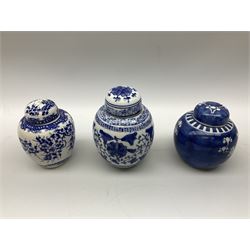 Six Chinese ginger jars, predominantly of blue and white design decorated with blossoming branches, all with lids, housed on various hardwood carved stands, some with character marks beneath