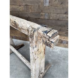 Pair of late 19th century pitch pine trestles, square tapering form in stripped finish