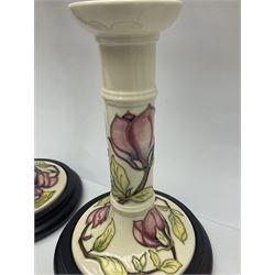 Pair of Moorcroft table lamps of candlestick form in magnolia pattern, with Moorcroft shades, H50cm 
