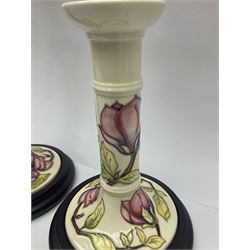 Pair of Moorcroft table lamps of candlestick form in magnolia pattern, with Moorcroft shades, H50cm 
