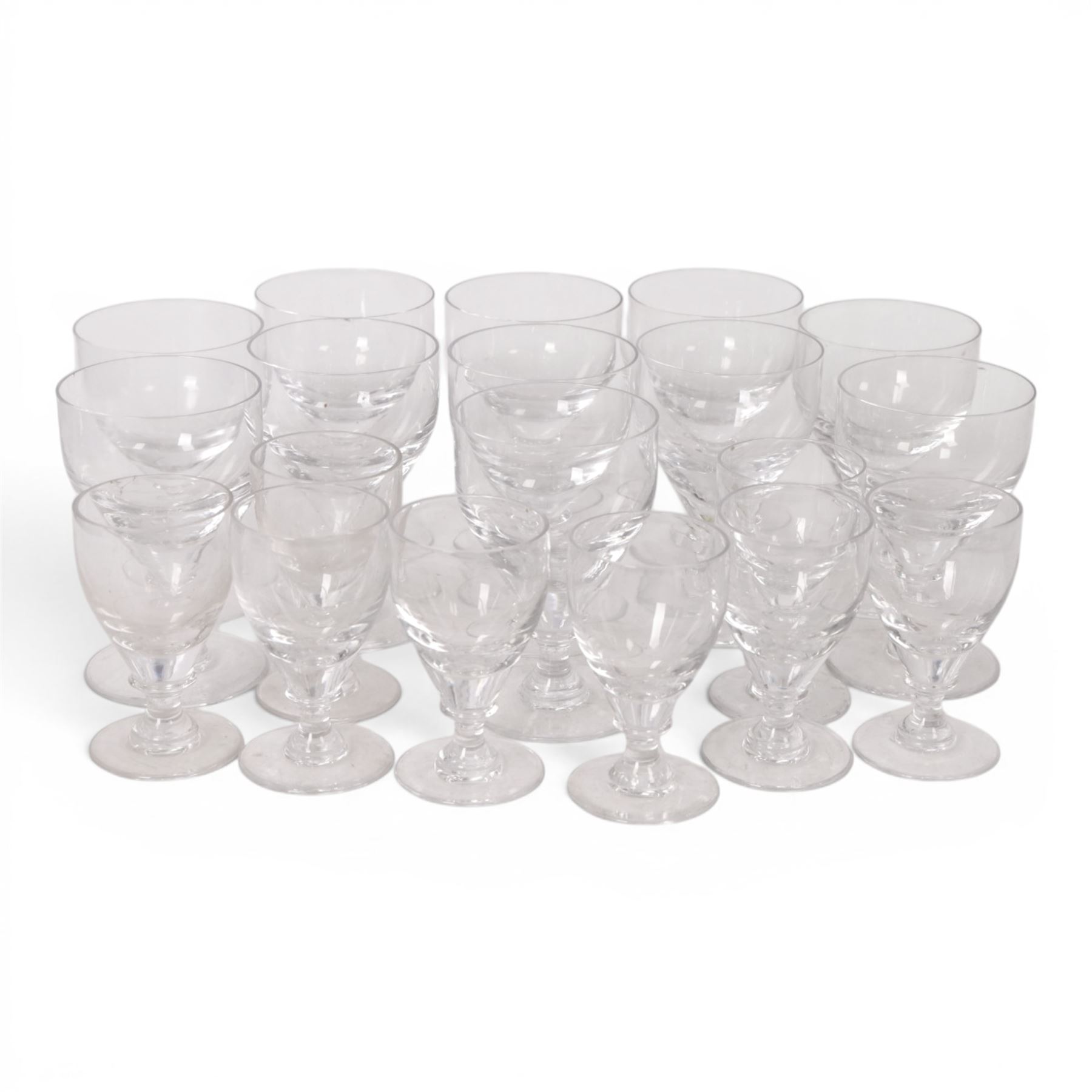 Georgian shaped drinking glasses, comprising eleven larger, H12.5cm, and eight smaller, H10.5cm, each with ovoid bowl upon knopped stem and circular foot