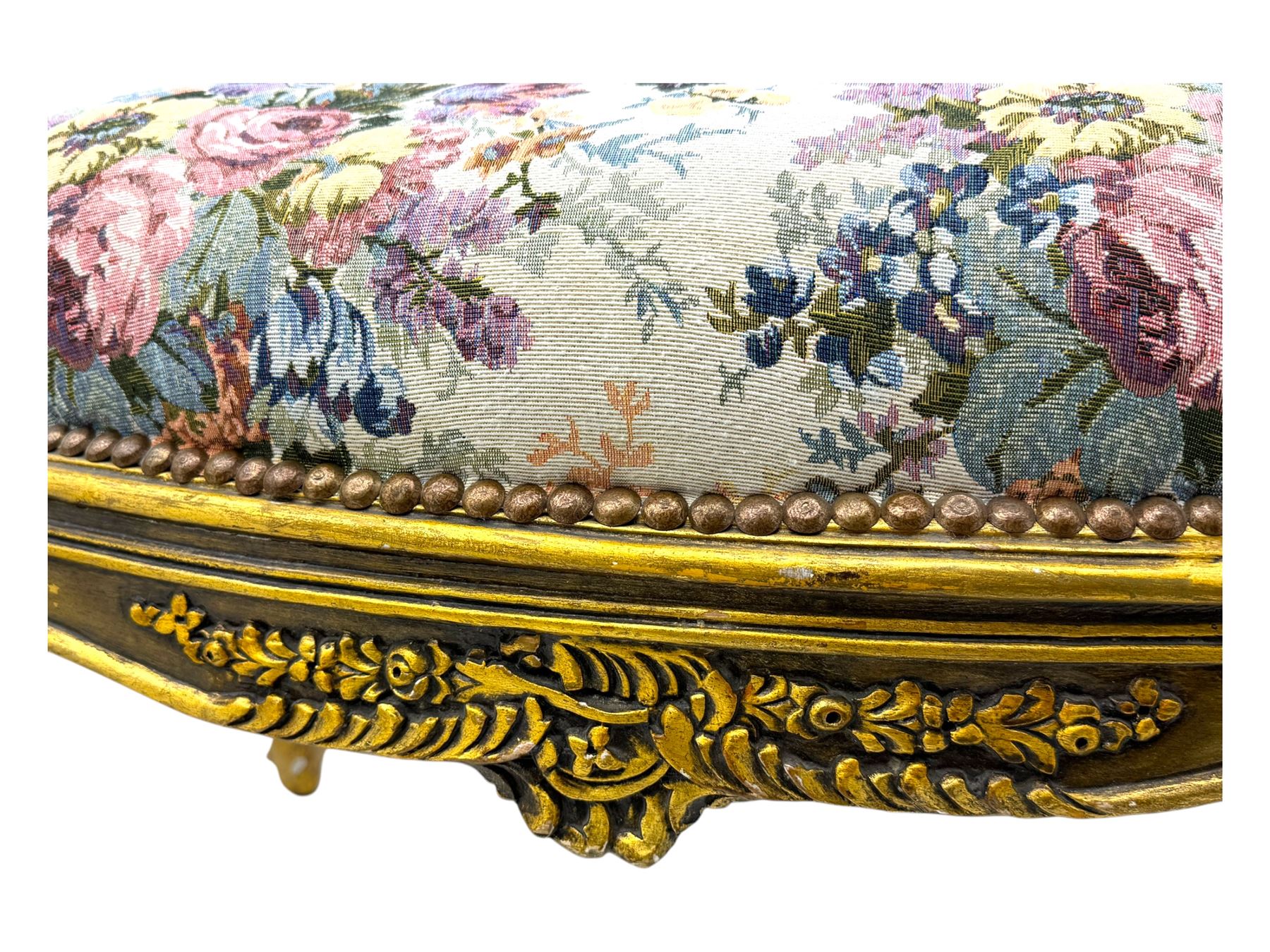 Pair of Louis XV-design giltwood stools, each upholstered in floral tapestry fabric, the carved frame adorned with scrolling foliage and shell motifs, raised on cabriole supports