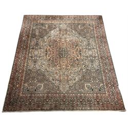 Large Persian design carpet, pale brown ground with scrolling floral decorated medallion, the field with all-over foliate designed with animal and bird motifs, multi-band border decorated with trailing foliage and stylised plant motifs