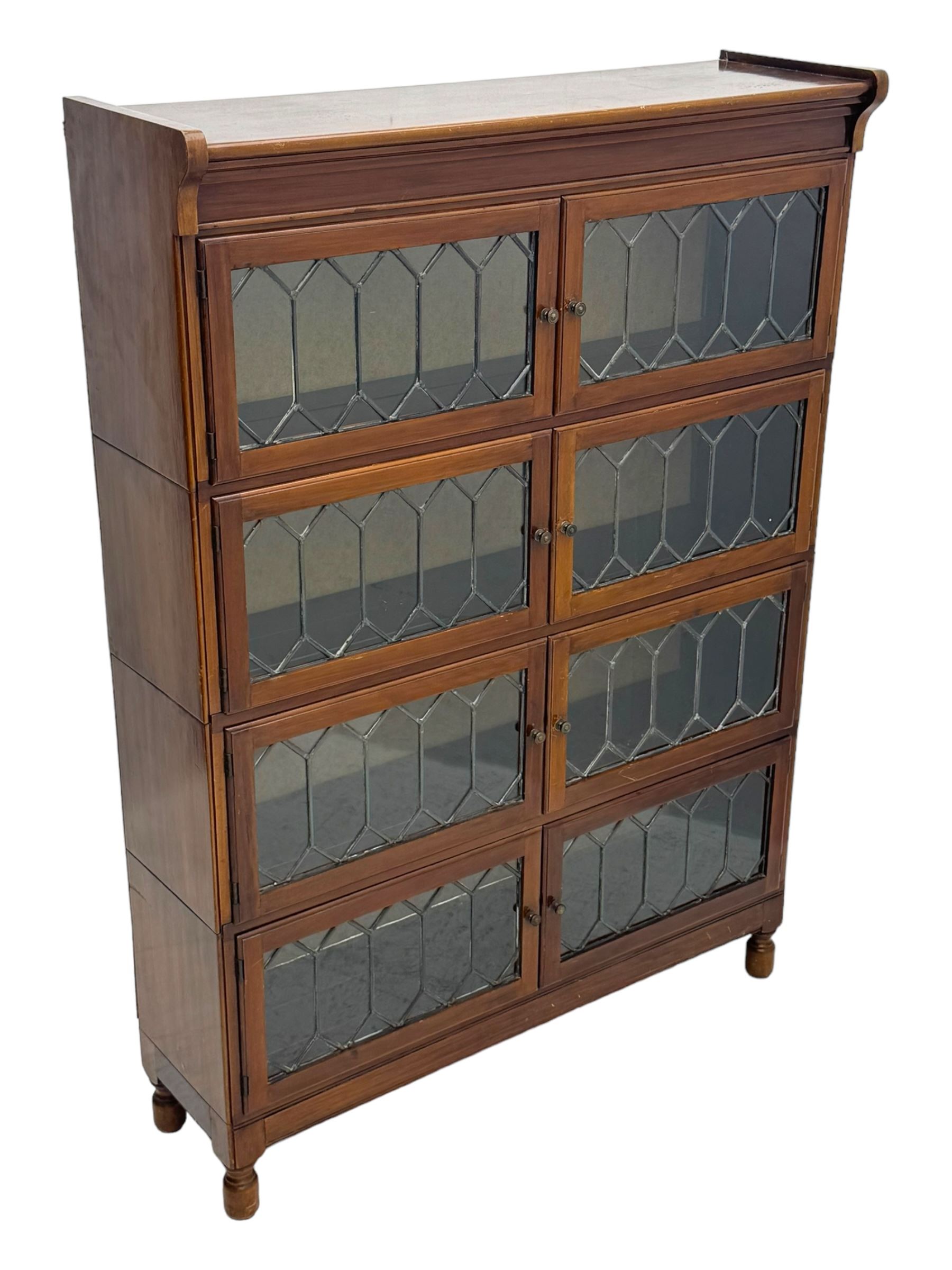 Early 20th century Globe Wernicke design stacking walnut bookcase, fitted with four sections each with two leaded glass doors, raised on turned feet