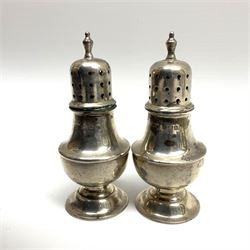 Two piece silver cruet set by E S Barnsley and Co, Birmingham 1907, stamped E.S.B, white metal tea caddy of octagonal form with foliate decoration, twin handles and shallow domed hinge lid, two pairs brass candlesticks, bottle holder and other metalware

