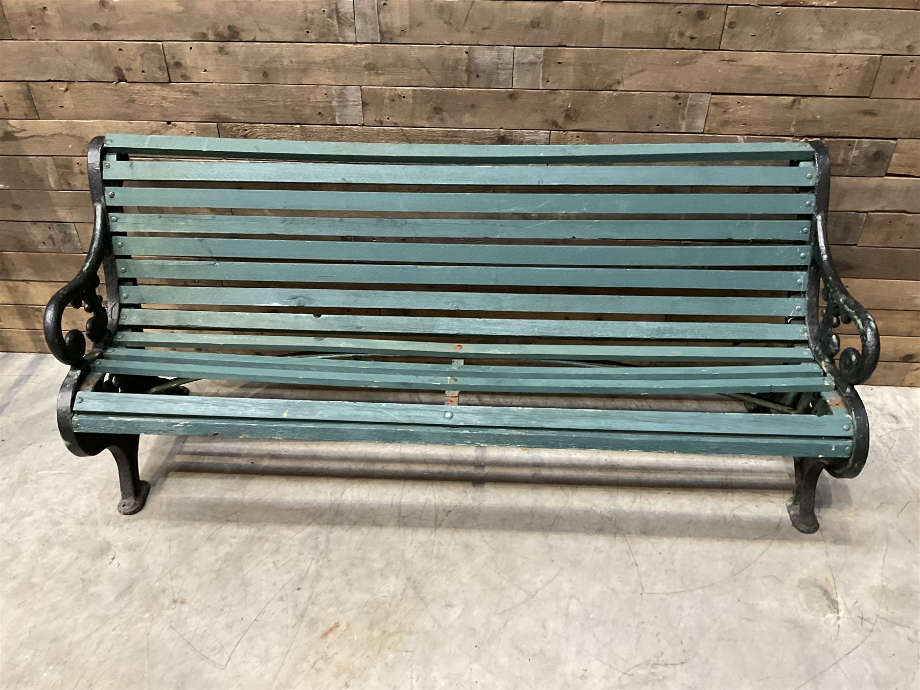 Early 20th century slatted garden bench with scrolling cast iron bench ends