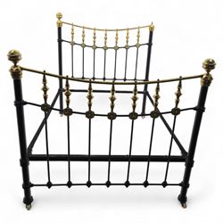 Victorian brass and iron 4' 6'' double bedstead, curved brass top rail with cast iron spindles and ornate floral rosettes flanked by urn shaped finials, foldable divan style base upholstered in a striped fabric, supported on turned posts and ceramic castors