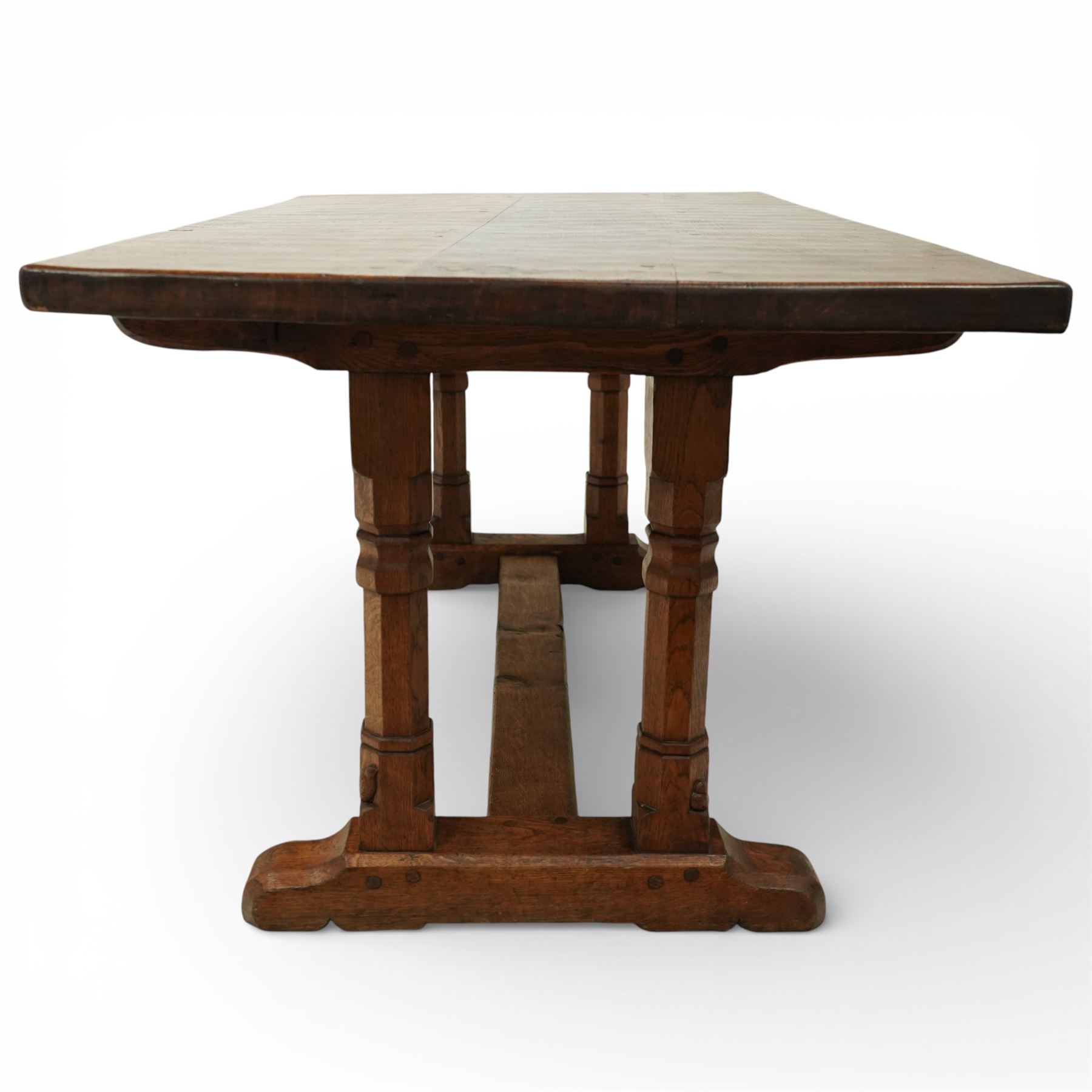 Mouseman - 1937 refectory table, Sir Herbert Baker commission for Westminster Church House, the rectangular adzed plank top above twin octagonal baluster supports united by a pegged stretcher, raised on shaped sled bases carved with a partridge and a loaf of bread, with carved mouse signature to inside leg, by Robert Thompson of Kilburn

The carved loaves reference the original patron, while the partridges are thought to represent Frank Partridge, Bishop of Portsmouth from 1877 to 1941, who played a key role in the founding of Church House and served as its Secretary from 1936 until 1941

Reference
Christie’s ROBERT “MOUSEMAN” THOMPSON; Refectory Table, Lot 188, sold at Christie’s London, commissioned by Sir Herbert Baker KCIE, RA, architect of Church House (opened 1937). Provenance and description available on the Christie’s website
https://www.christies.com/en/lot/lot-4618786