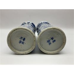 Pair of Chinese blue and white cylindrical vases, decorated with bird and flowers surrounding central figures holding a large vase, H20cm