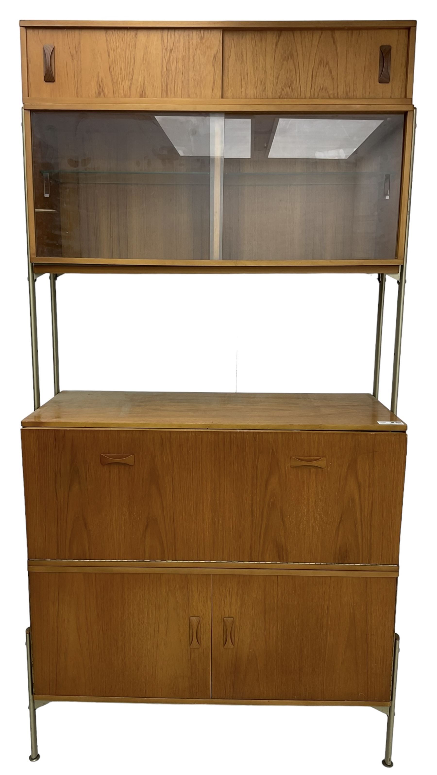 Remploy - mid-20th century teak sectional wall display unit or room divider, raised display cabinet section with sliding glass doors, central fall front section, lower double cupboard section and an additional sliding door section 