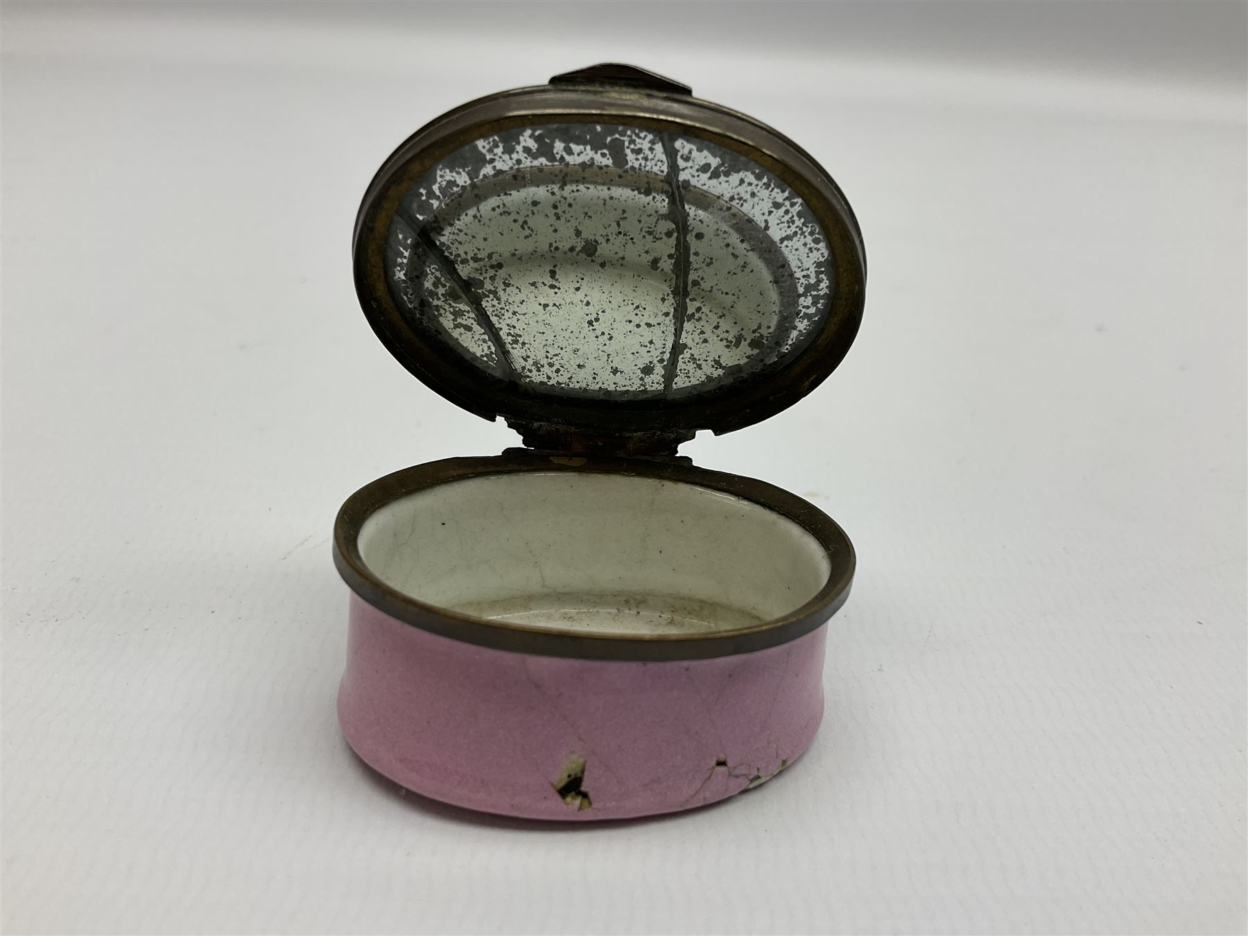 Late 18th century Staffordshire enamel patch box, of oval form with pink base, the hinged cover inscribed 'Have Communion with few, Be familiar with One, Deal justly with All, Speak evil of none' upon a white ground, opening to reveal mirror beneath, W4cm