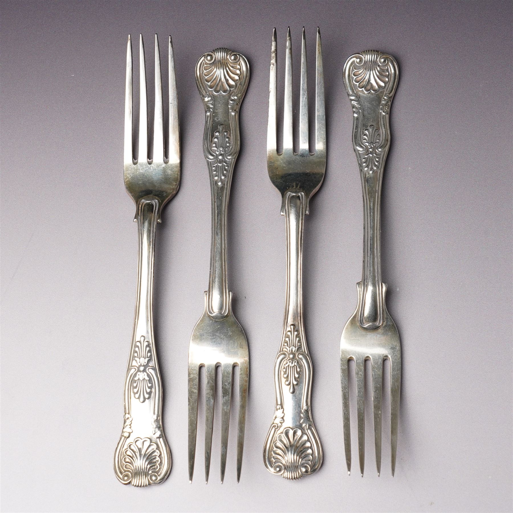 Set of six George IV silver Kings pattern dessert spoons London 1825 Maker Charles Eley  and four 19th century Kings pattern silver dessert forks, various dates