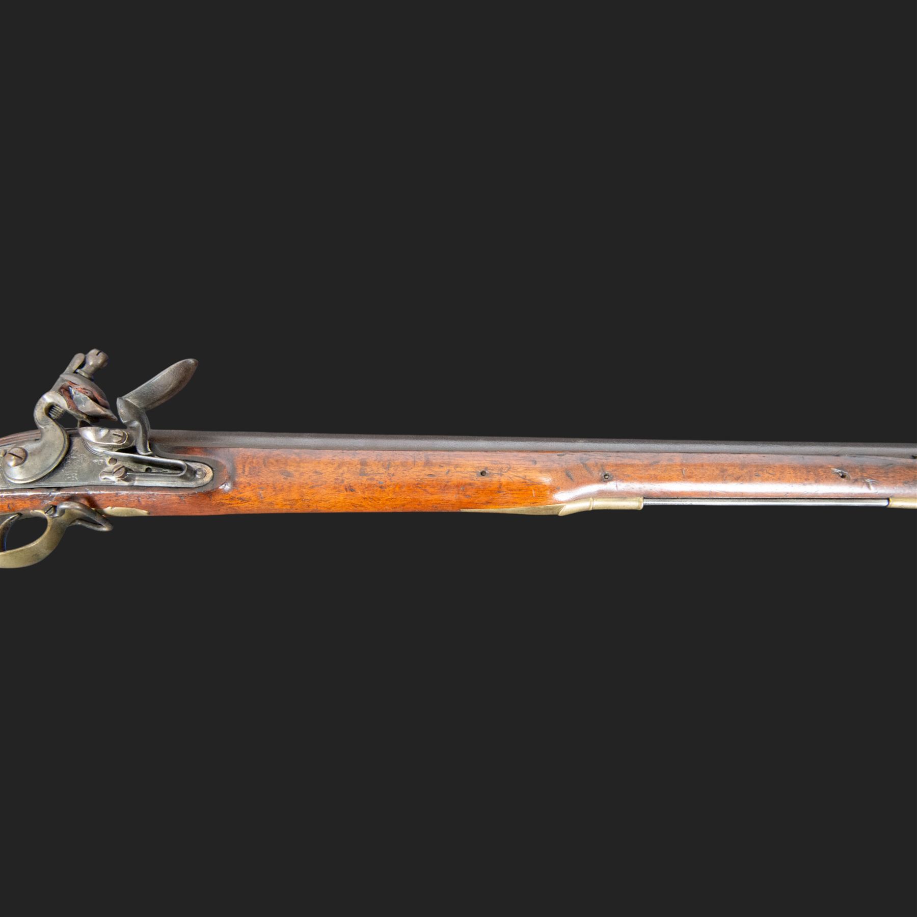 Brown Bess flintlock musket, 37in barrel, action marked with crowned GR and Tower, with brass mounts, the thinned butt marked 38, sling swivels, steel ramrod, overall L132cm
