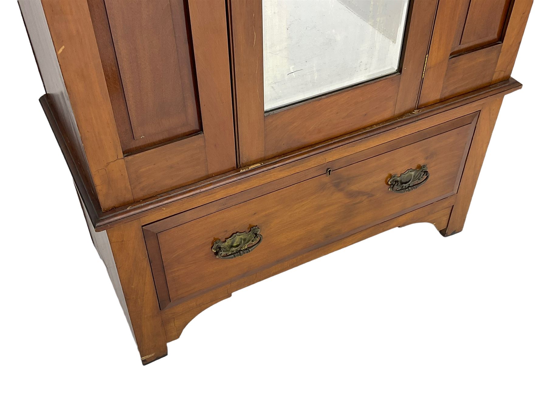Edwardian walnut single wardrobe, projecting cornice over panelled front and bevelled mirror glazed door, single drawer to base