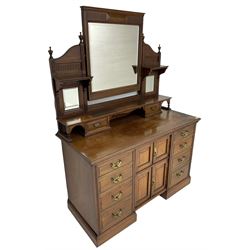 Edwardian mahogany dressing chest, raised triple mirror back with bevelled plates and fluted decoration over two trinket drawers, the base fitted with two central cupboards flanked by four graduating drawers to each side