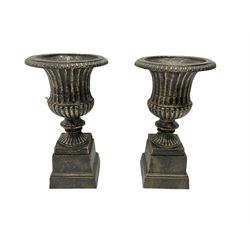 Pair Victorian design cast iron Campana shaped garden urns with base, in black and gilt finish 