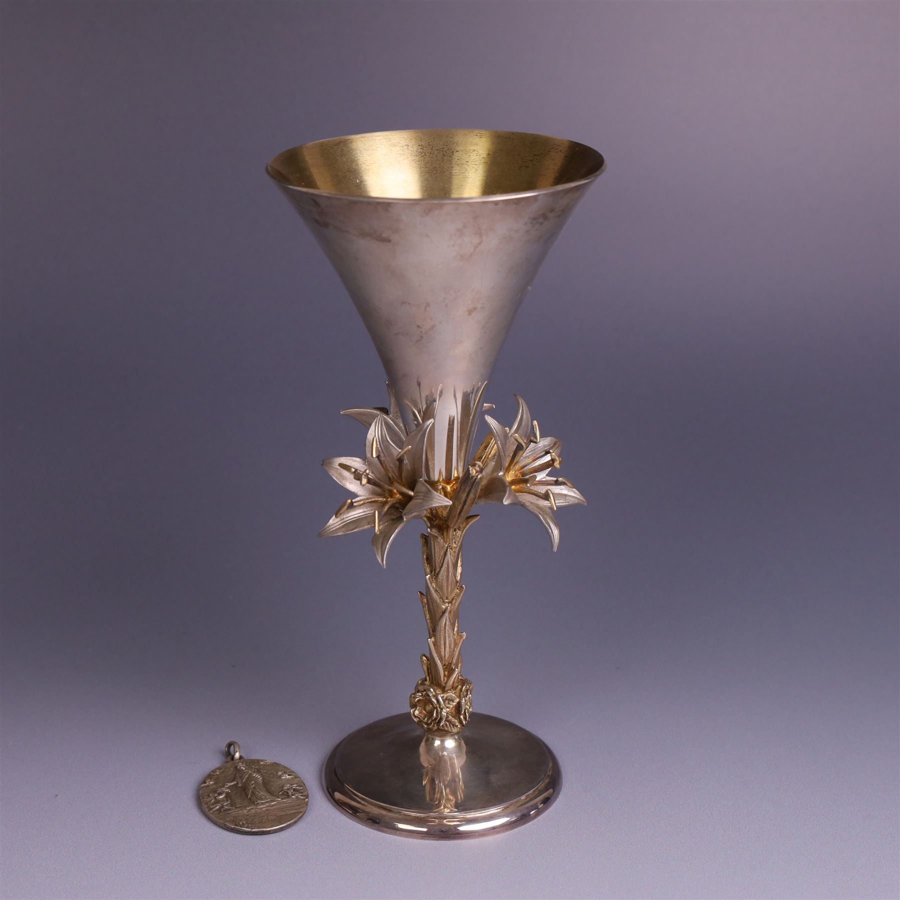 Modern limited edition silver goblet, 'made by order the provost and charter of Blackburn to commemorate the fiftieth anniversary of the cathedral in 1976 and its consecration in 1977' designed by Hector Miller for Aurum, the plain fluted cup, upon a stem of three lillies with parcel gilt highlihts and upon a circular foot, no. 2/750, hallmarked Hector Miller, London 1977, H17cm, boxed with certificate of authenticity