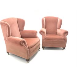 Pair early 20th century wing back armchair upholstered in a coral fabric, bun feet on castors