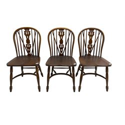 Set three late 20th century country oak Windsor chairs, hoop and stick back with pierced and fretwork work splat, dished seat on turned supports joined by crinoline stretcher 