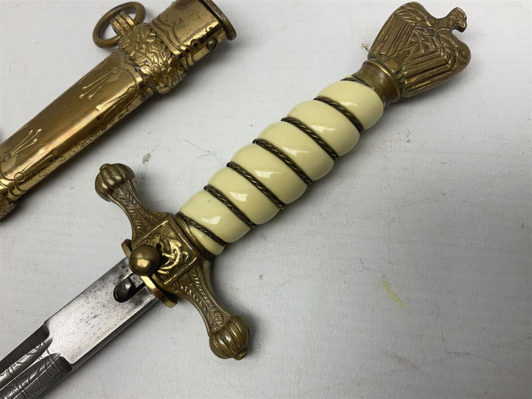 WW2 German kreigsmarine style dagger composed from various age parts, the post-war 25cm double fullered blade  with etched decoration and inscribed WKC with knight's head; in gilt brass scabbard with two rings L42cm overall
