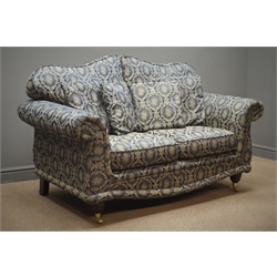  Two seat traditional style sofa floral pattern upholstery with mahogany feet on brass castors, W158cm  