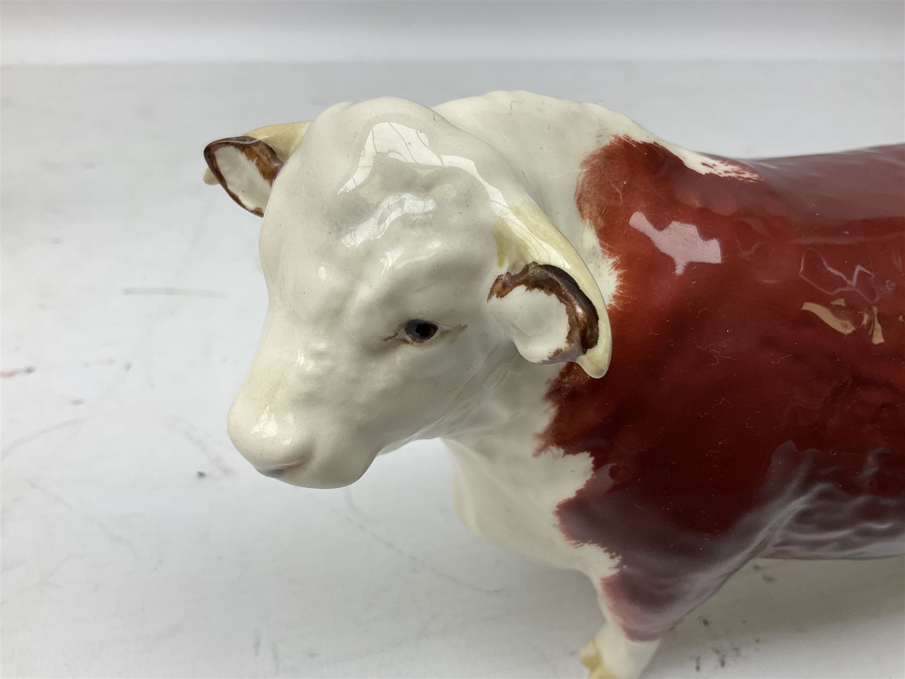 Three Beswick models comprising Hereford Bull no 949, 'CH Cutmil Cupie' Pug, and bay Shire horse, all with printed marks beneath
