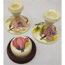 Moorcroft Anenome pattern plate, D26cm, pair Magnolia pattern candlesticks & paperweight (4)  