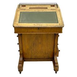 Early 19th century burr walnut Davenport desk, sloped leather-inset writing surface with brass gallery, fitted with an inkwell compartment and pen slot, four drawers to one side, raised on scrolled supports terminating in castors