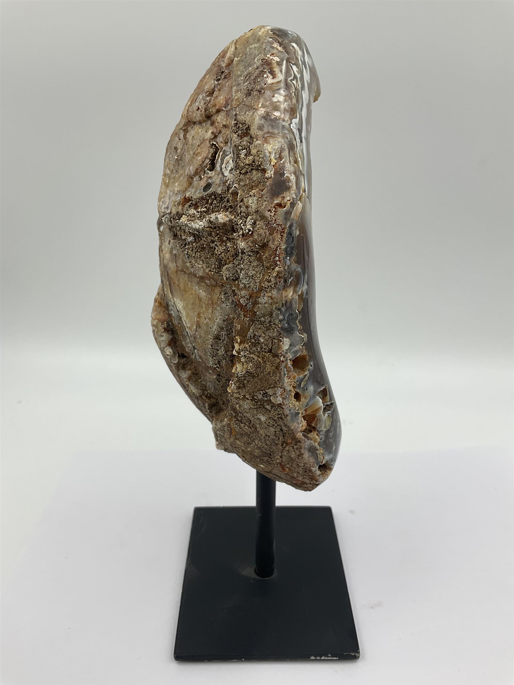 Agate crystal geode cluster, in brown and purple tones, upon a metal stand, H26cm