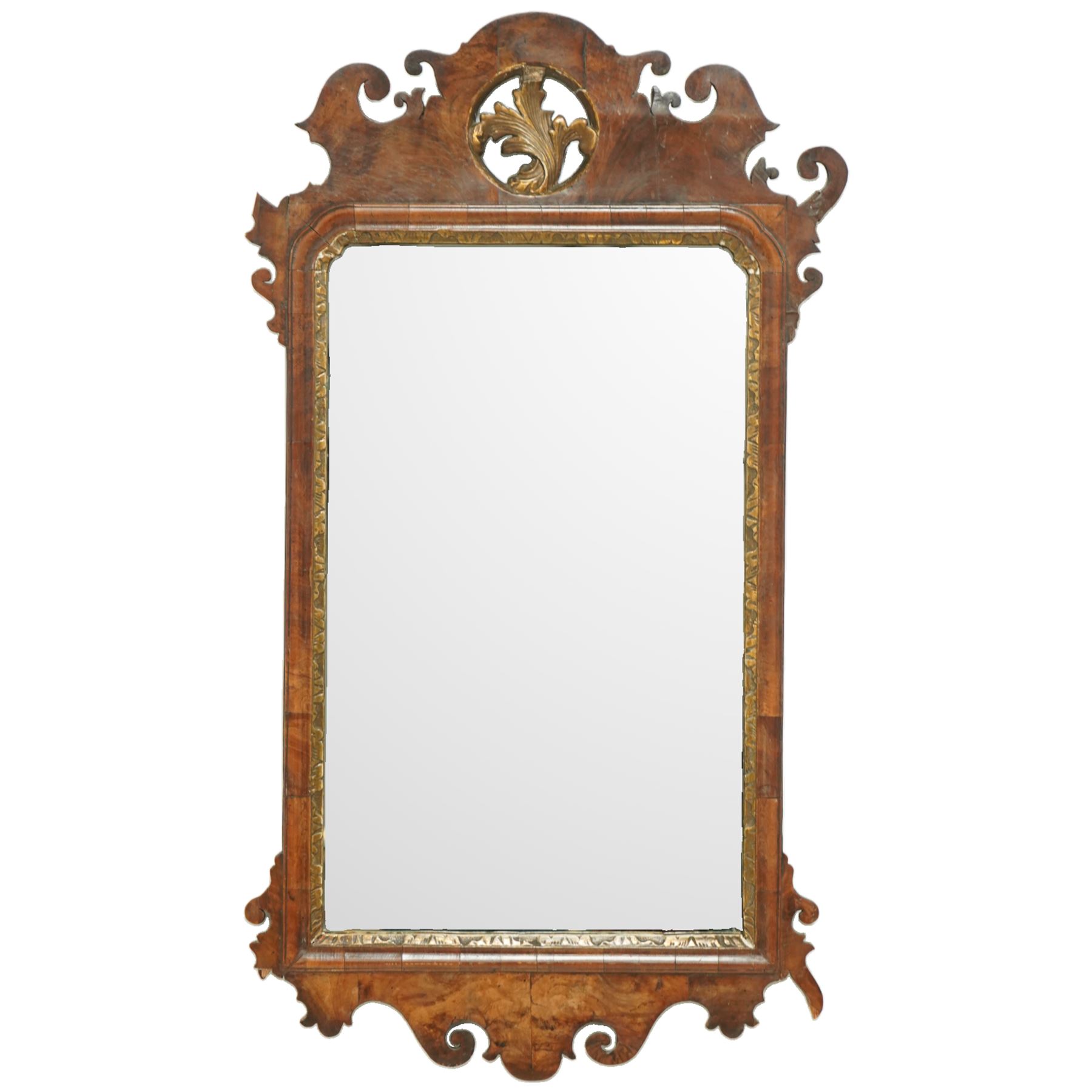 18th century Chippendale design walnut wall mirror, shaped and scroll carved cresting with central gilt acanthus roundel, moulded frame with inner gilt slip, shaped apron and scroll carved corners