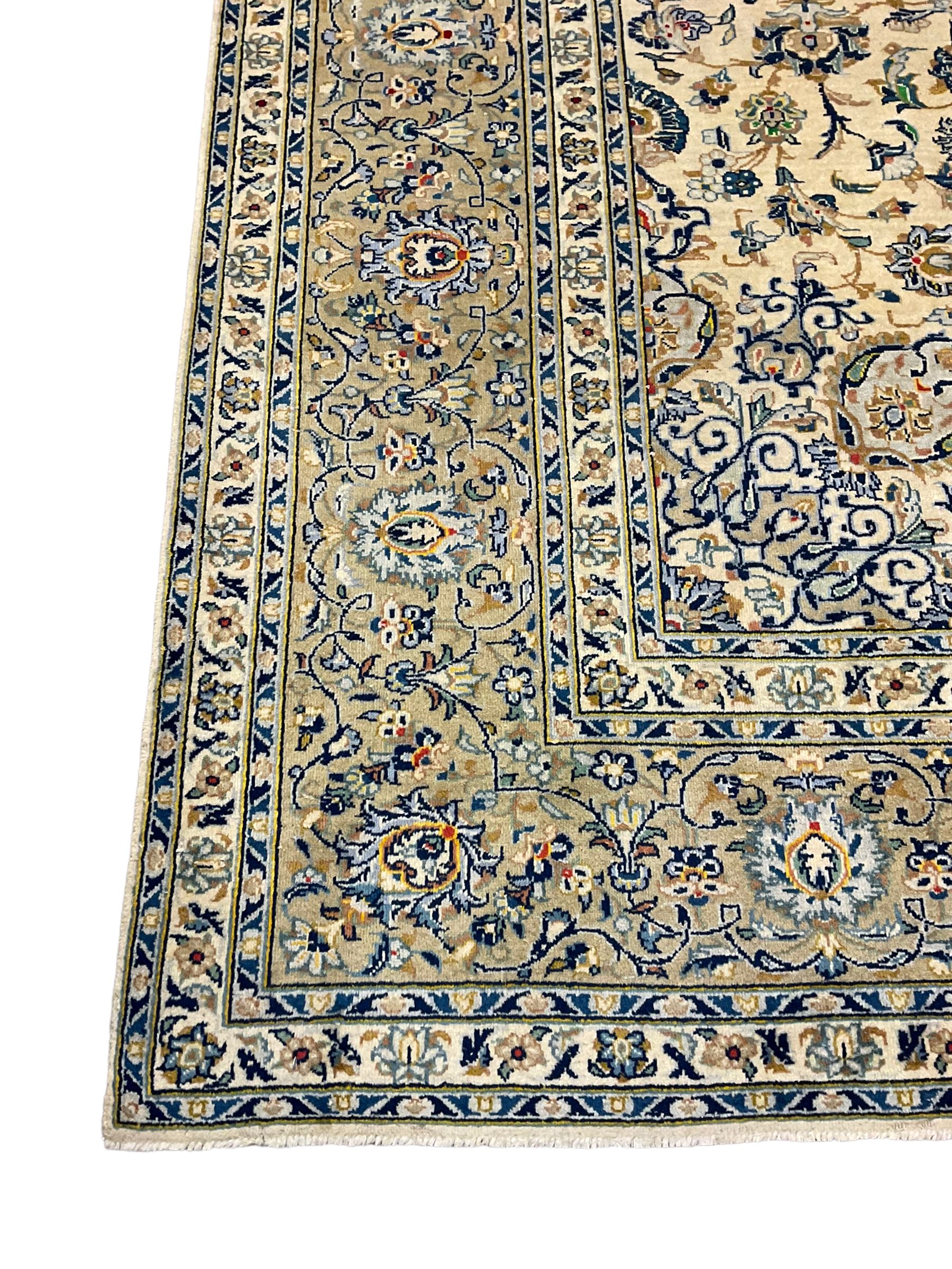 Central Persian Kashan carpet, decorated all-over with interlacing floral design, scrolling border with stylised plant motifs, with signed panel
