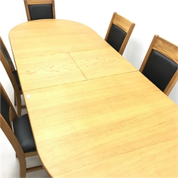 Oval solid oak extending dining table,  two turned columns on shaped supports joined by stretcher (W200cm and 250cm, H68cm, D101cm) and six oak framed chairs, upholstered back and seat (W44cm)