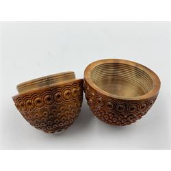 Three 19th century coquilla nut pomanders or flea catchers, two of egg shaped form and the third of barrel from with carved and pierced decoration and screw threaded join, largest H8cm
